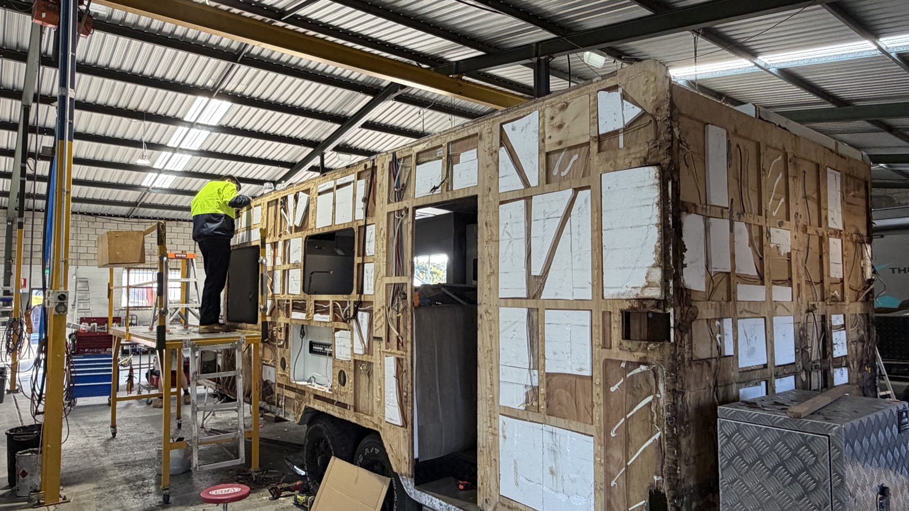 Technician repairing caravan exterior systems