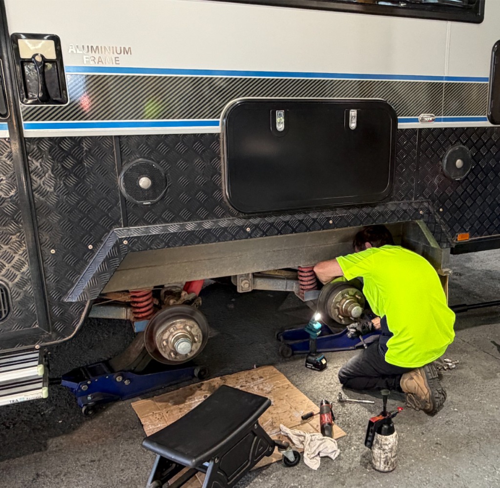 Technician servicing caravan brakes and suspension in the Torque workshop